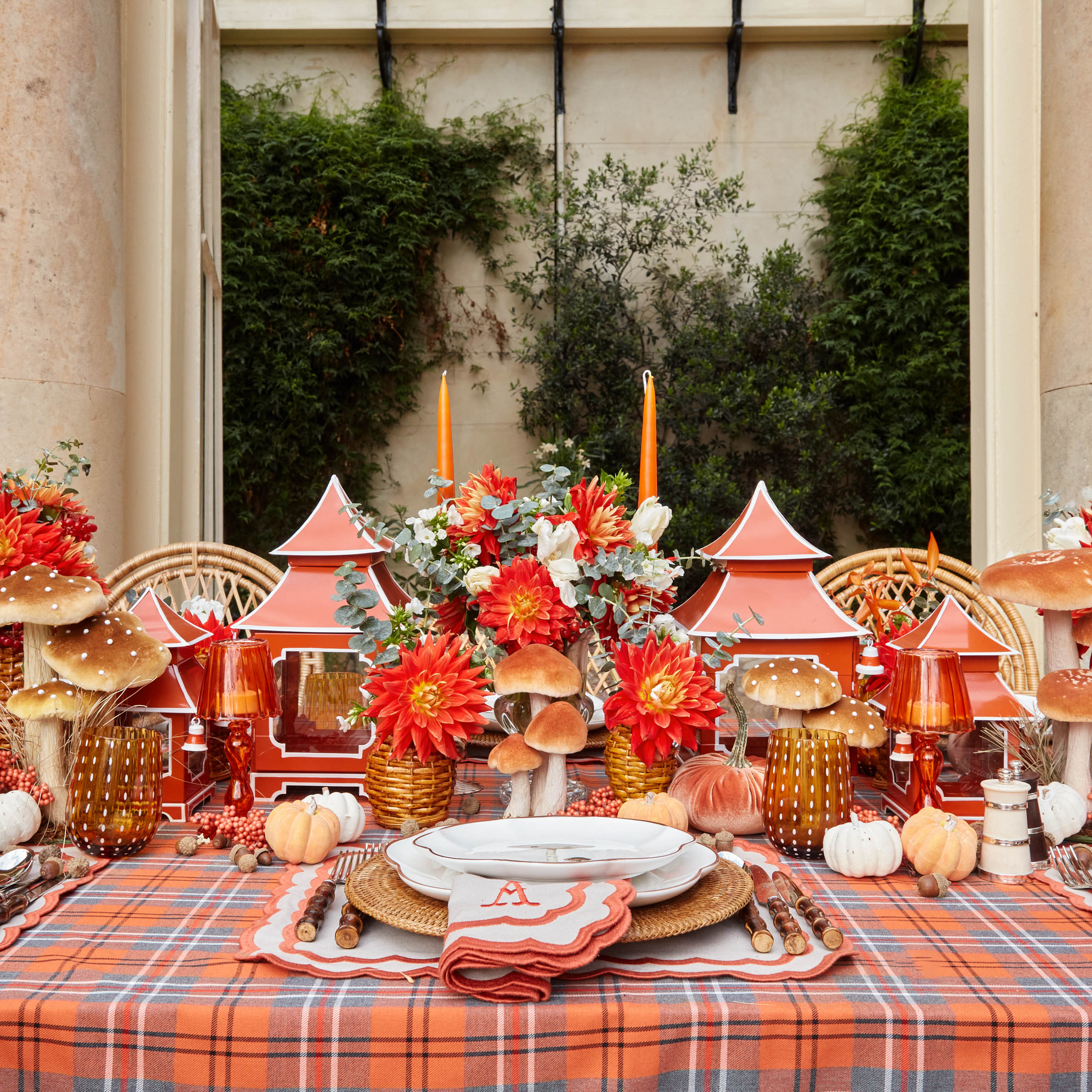 Eight handmade candles in a striking and vivid orange hue.