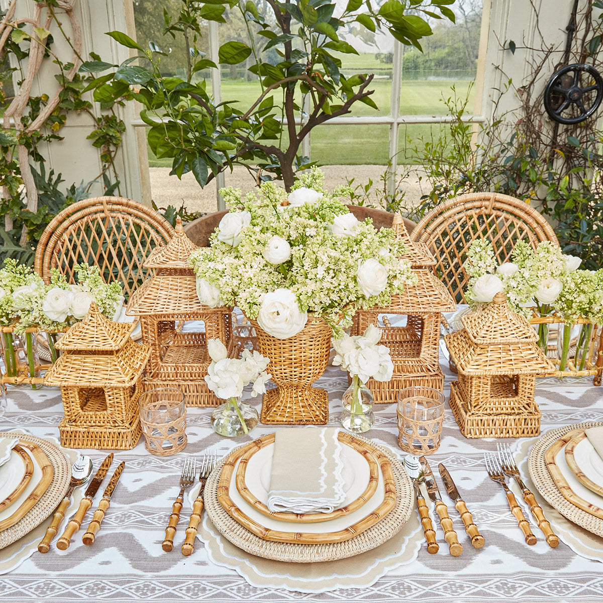 Set of two vases crafted in natural rattan, one pagoda and one urn.