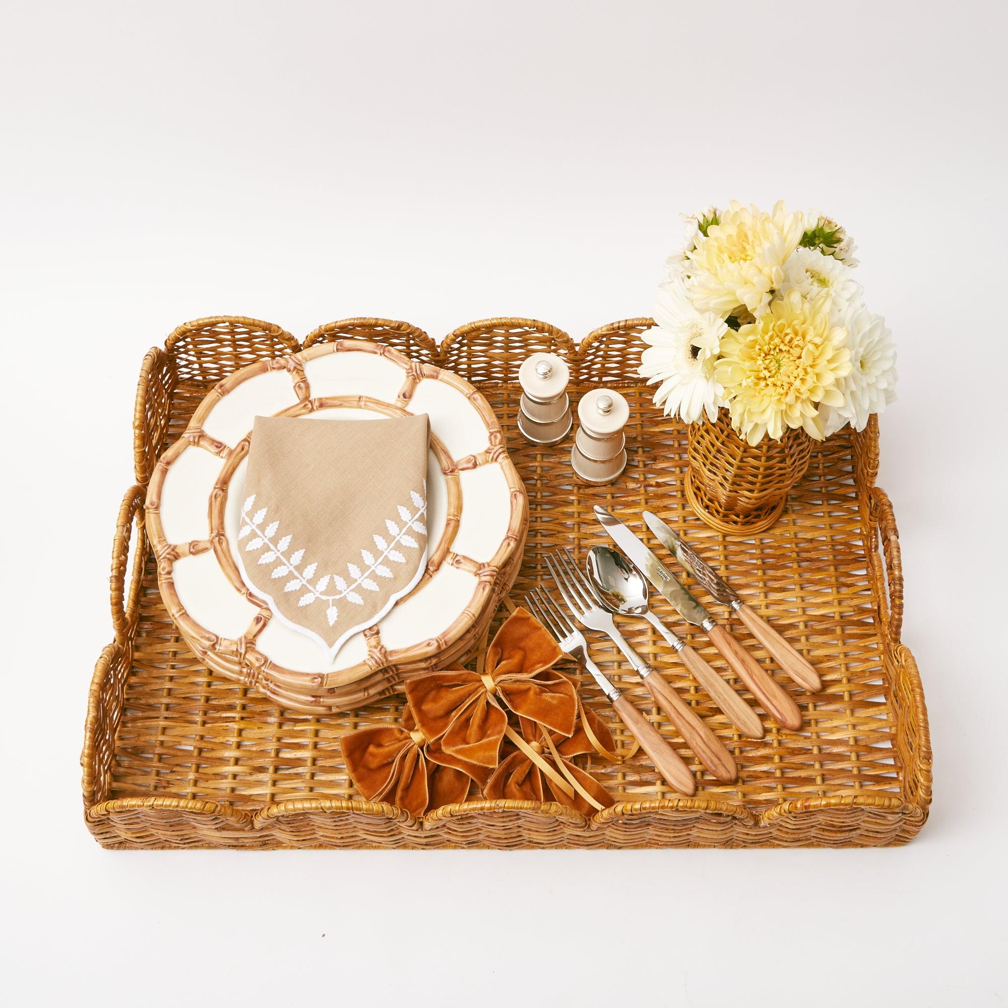 Duo of coordinated ivory salt and pepper containers for dining.