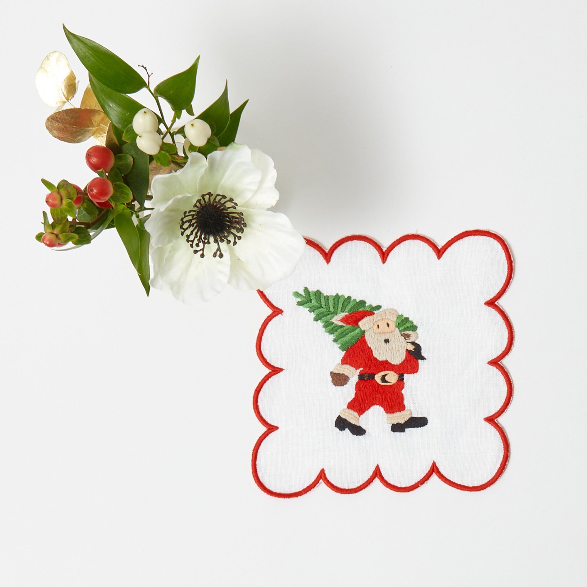 Impress your guests with the whimsical appeal of Scalloped White Embroidered Father Christmas Cocktail Napkins.