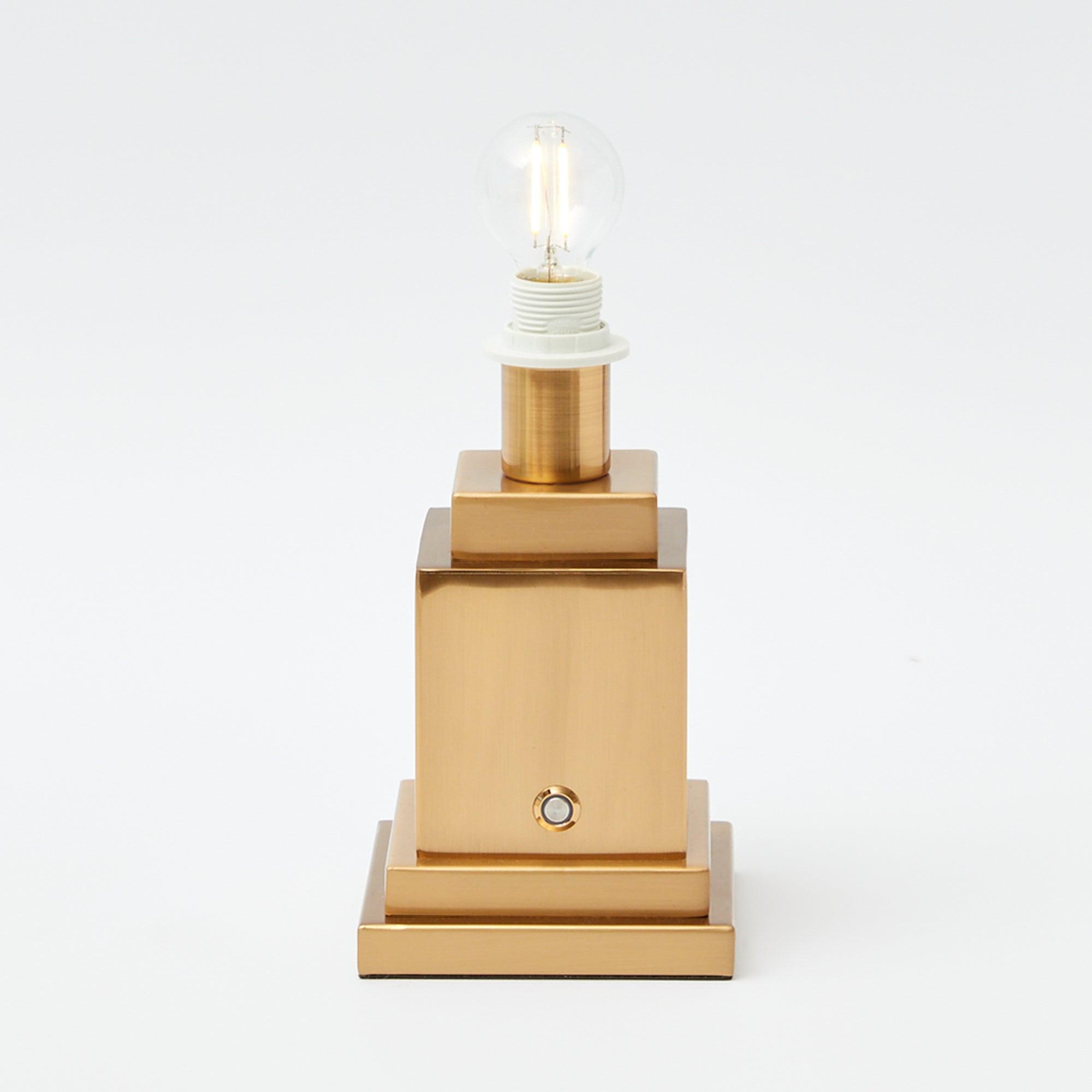 Stand for a rechargeable table lamp, offering versatile placement.